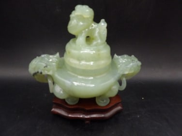 Chinese carved jade incense burner with foo dog lid and rings on wooden base