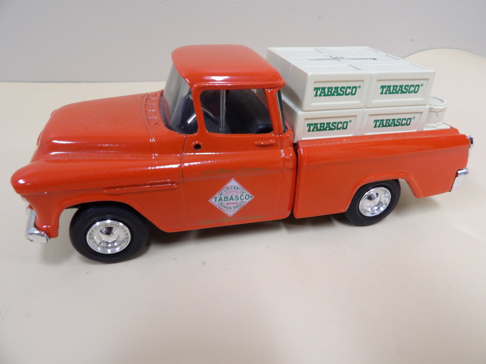 Ertl metal coin bank featuring 1955 Chevrolet Cameo pickup truck no 1644: Marked 1644. 7.3 inches length. Branded with Tabasco.