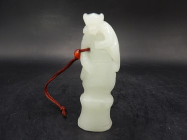 Chinese white jade carved monkey on top of tree branch