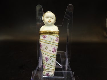 antique French porcelain bottle in the form of an infant in swaddling clothes