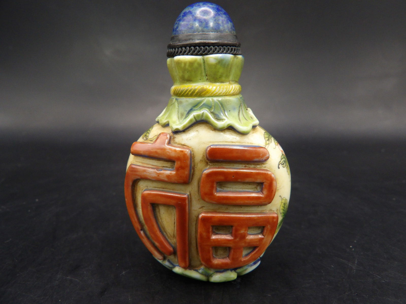 Chinese Qing dynasty Qianlong mark overlay glass snuff bottle with peach and calligraphy: Lapis lazuli stopper. 2.4 inches height.