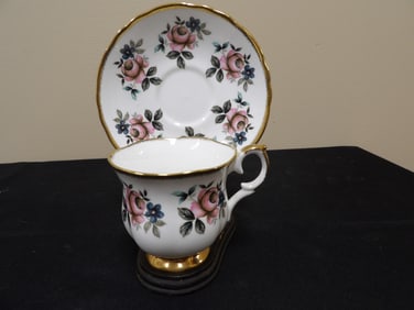 Staffordshire England bone China cup and saucer with gold rim on wooden stand