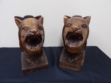 Pair of hand carved wood bookends featuring roaring lion heads
