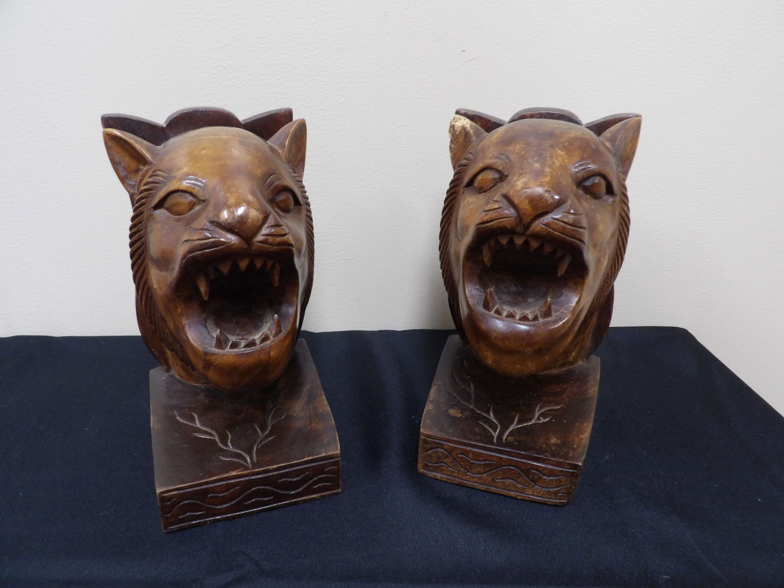 Pair of hand carved wood bookends featuring roaring lion heads: Size is 4.5 x 5.4 x 8.4 inches.