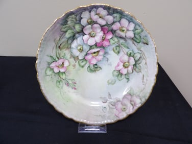 hand painted porcelain plate with gold rim and floral motif probably Limoges circa 1900 - 1920