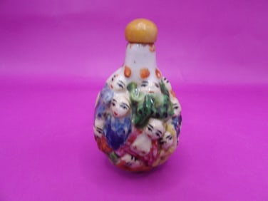 Chinese molded porcelain snuff bottle with many arhats