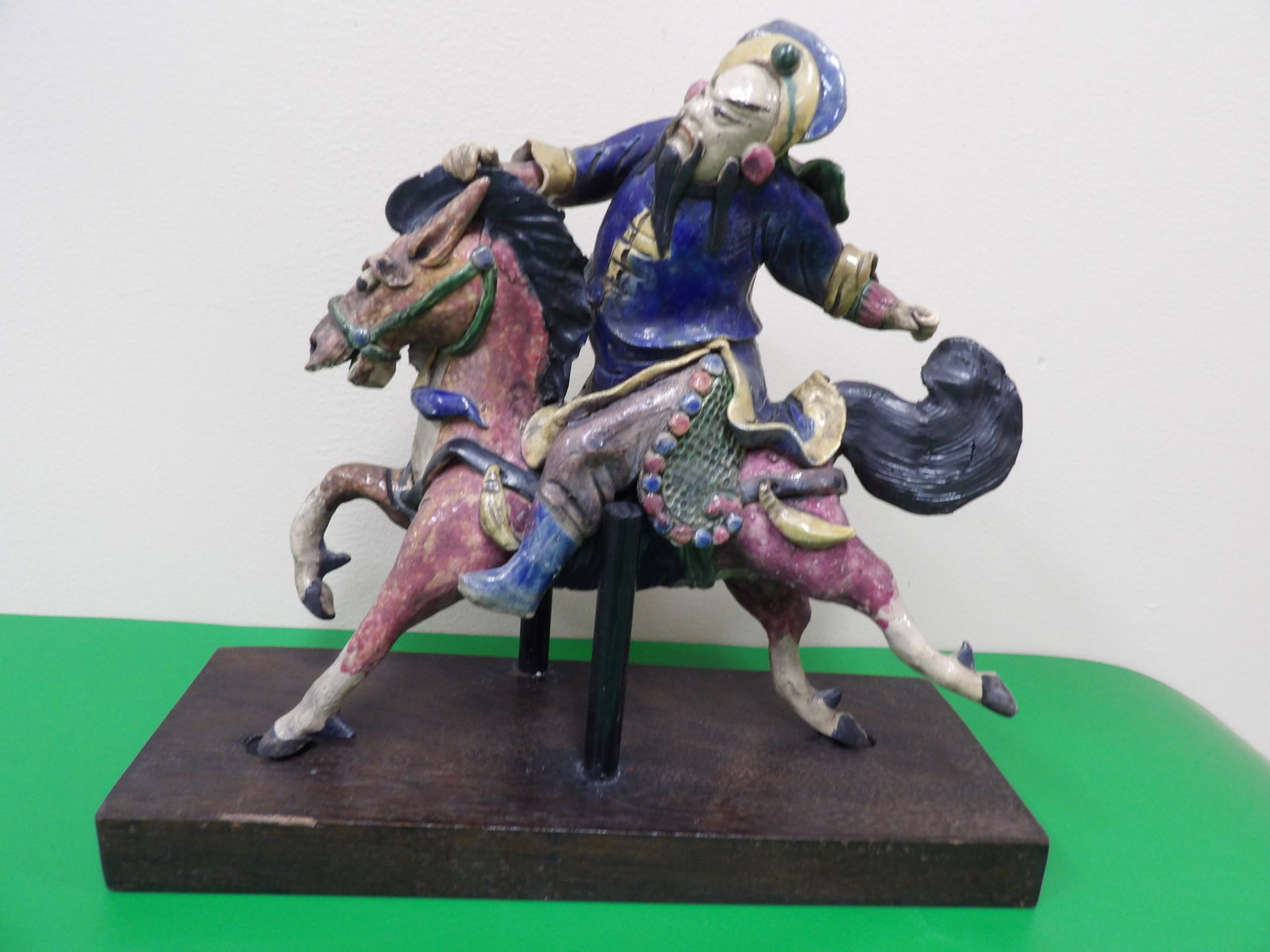 antique Chinese roof tile of warrior riding a horse on wooden base (1 of 7)