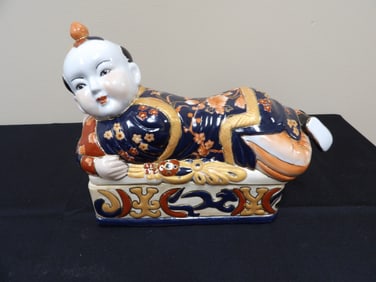 Chinese molded porcelain lying boy figural lidded box