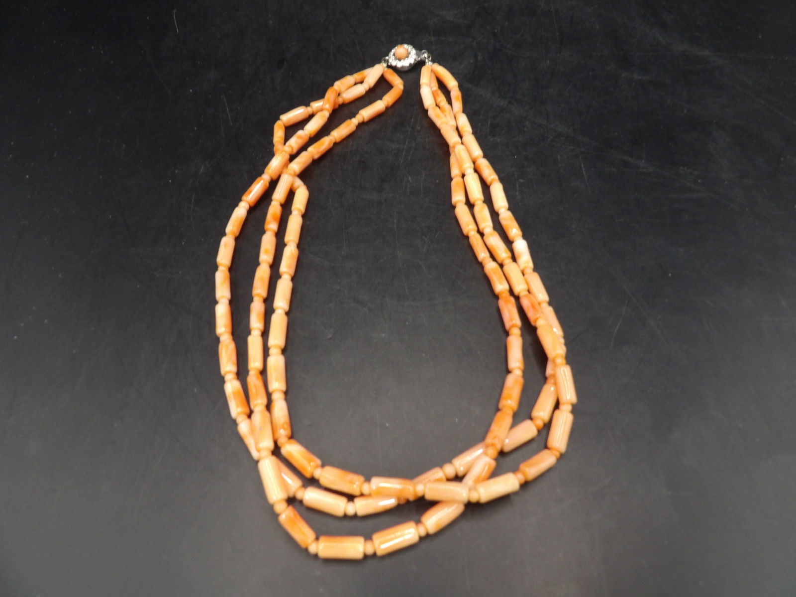 triple layers angel skin coral necklace with silver clasp marked: 17 inches long.