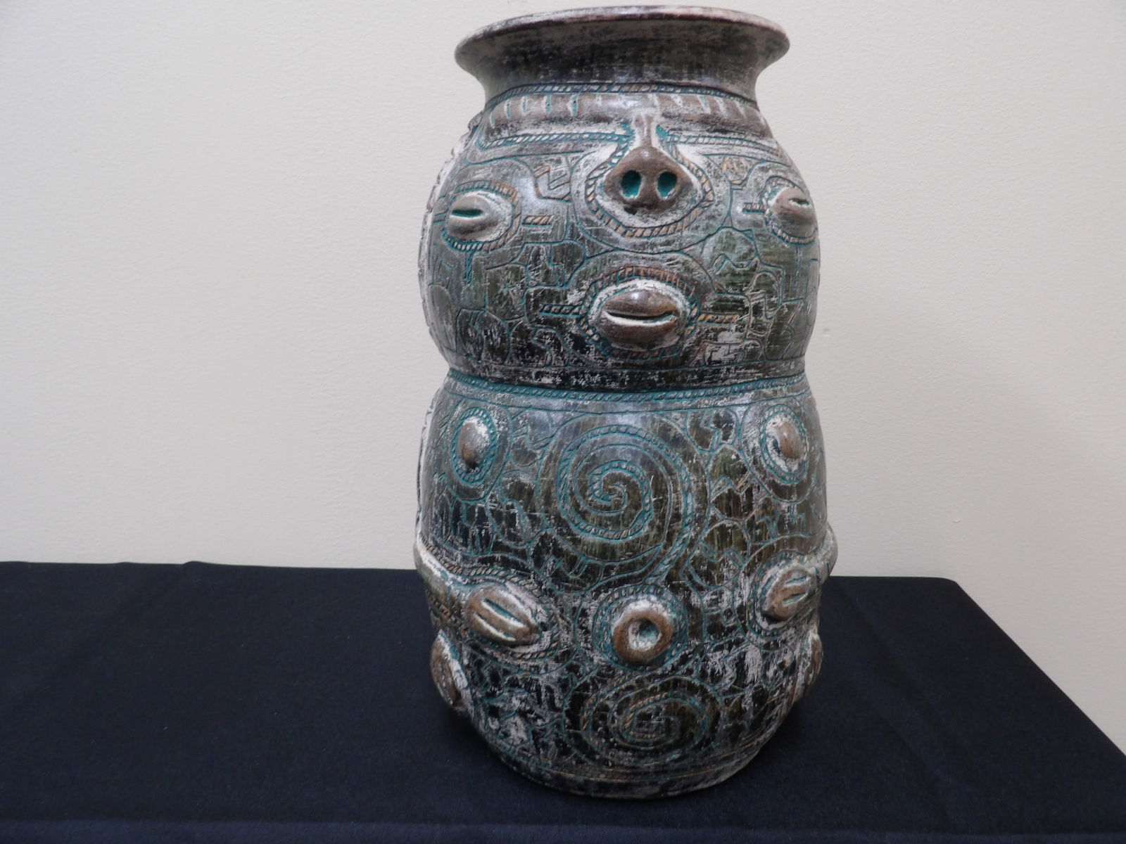 Brazilian glazed and incised pottery vase with face motif 12 inches height: 12 inches height.