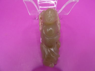 Antique Chinese jade carving of a boy holding lotus leaf