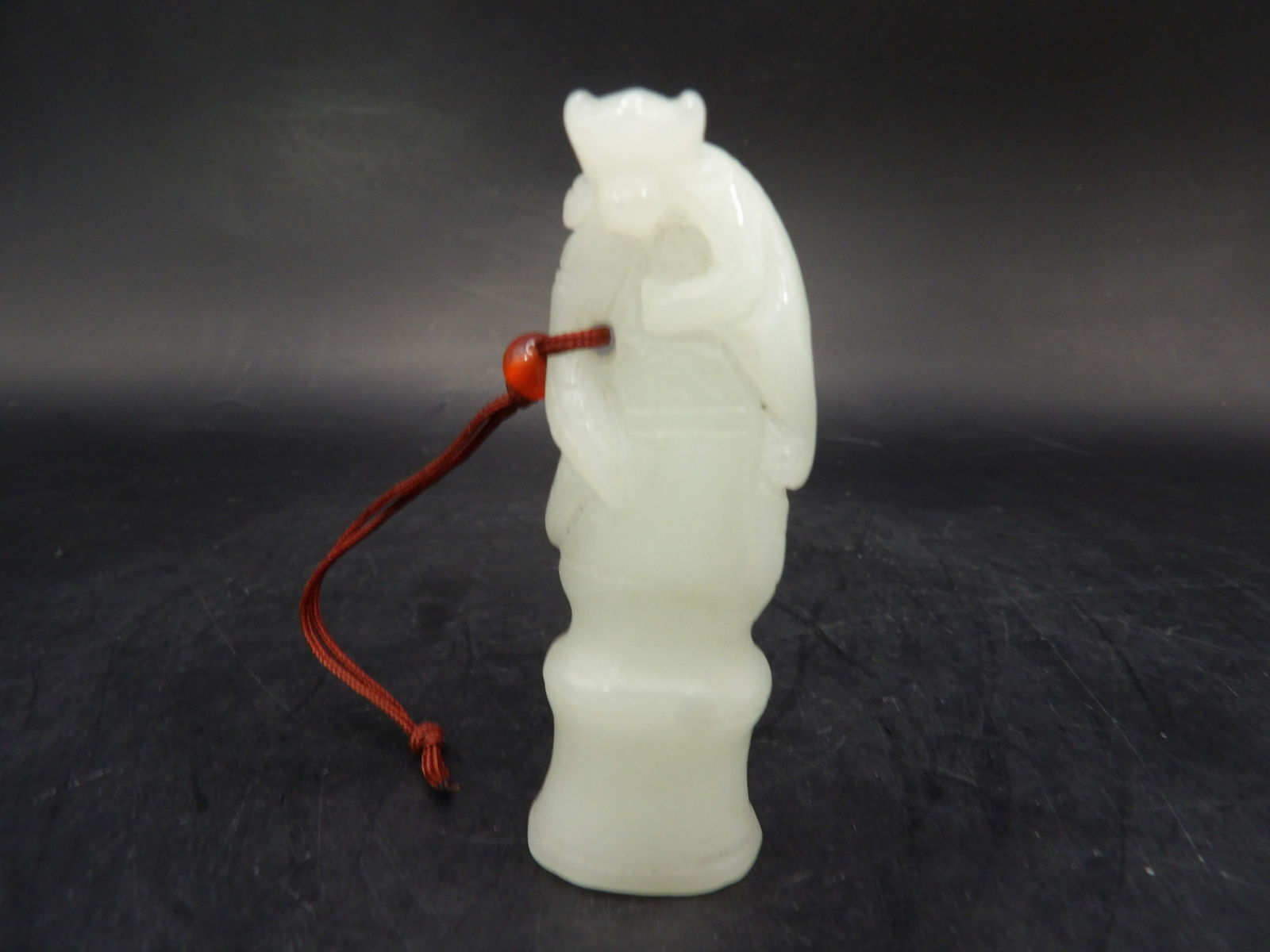 Chinese white jade carved monkey on top of tree branch: 2.7 inches height. 26 grams.