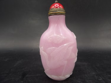 rare carved pink glass snuff bottle with crane flower clouds and Qing dynasty Qianlong mark