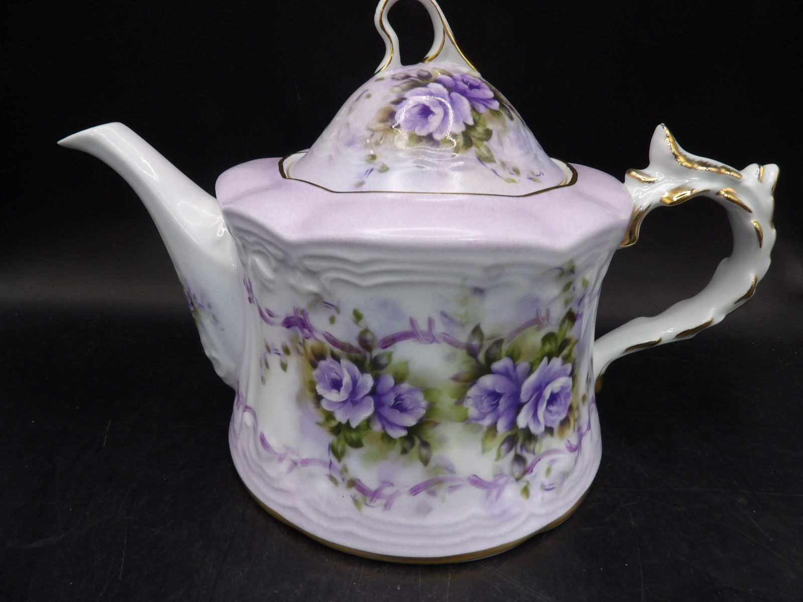 large Chinese Musical porcelain teapot with gold rims and pastel floral decoration: Working condition. 10 inches length.
