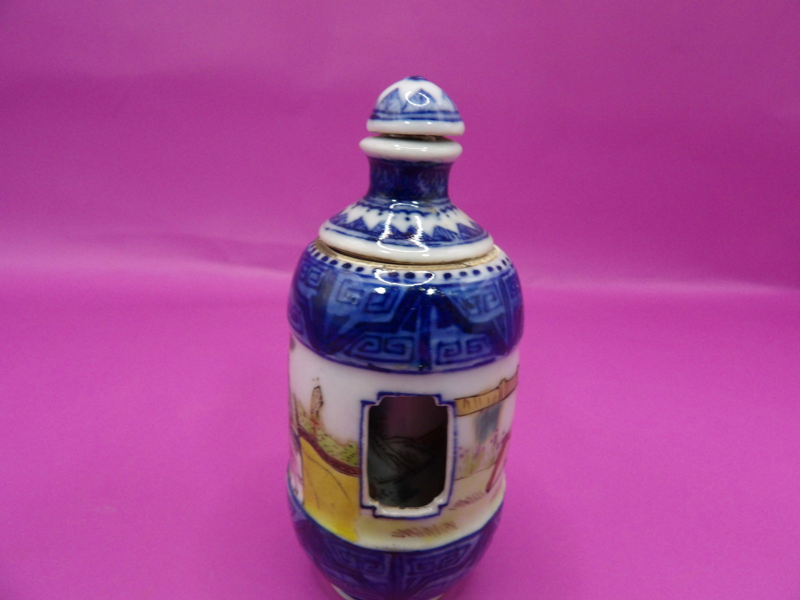 Chinese rotating porcelain snuff bottle with Qing dynasty Qianlong mark and warrior motif: 3 inches height.