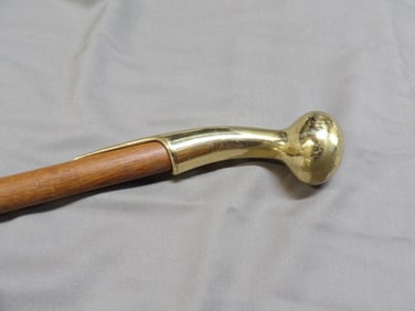 vintage walking stick cane with a brass Derby handle and wooden shaft