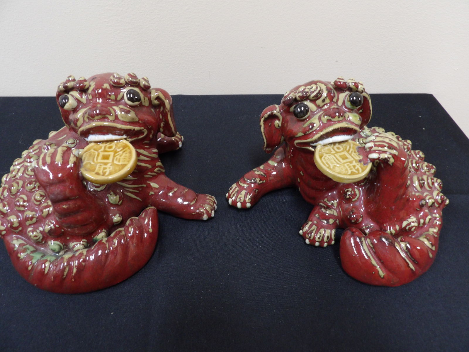 pair of Chinese guardian lions holding Chinese coins statues: 7 inches length.