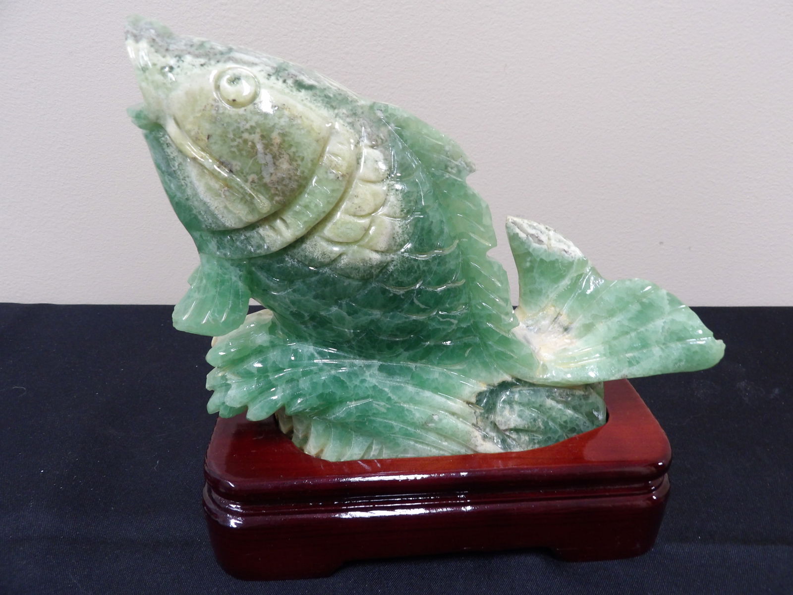Chinese green agate or quartz carved fish sculpture on custom wood base: 7.5 inches height including wood base.
