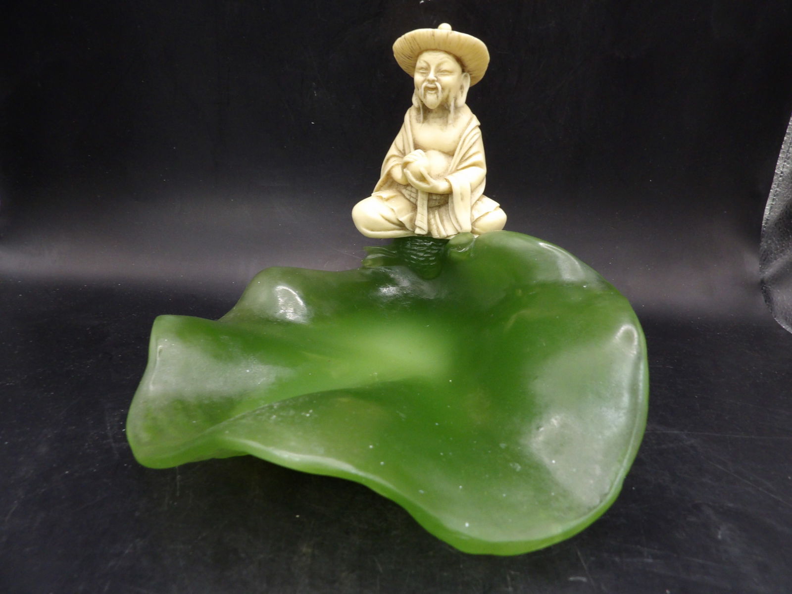 Jade color lotus leaf catchall dish plate with a male Asian figure: 7 inches length.