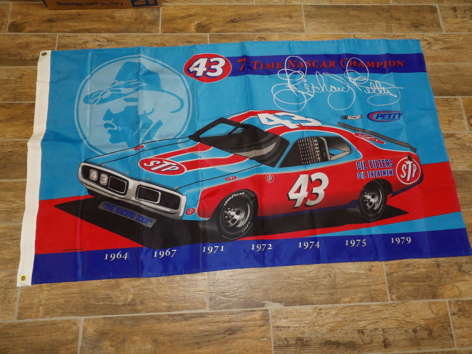 A large flag commemorating Richard Petty's Nascar career: Size approx. 60 x 34 inches.