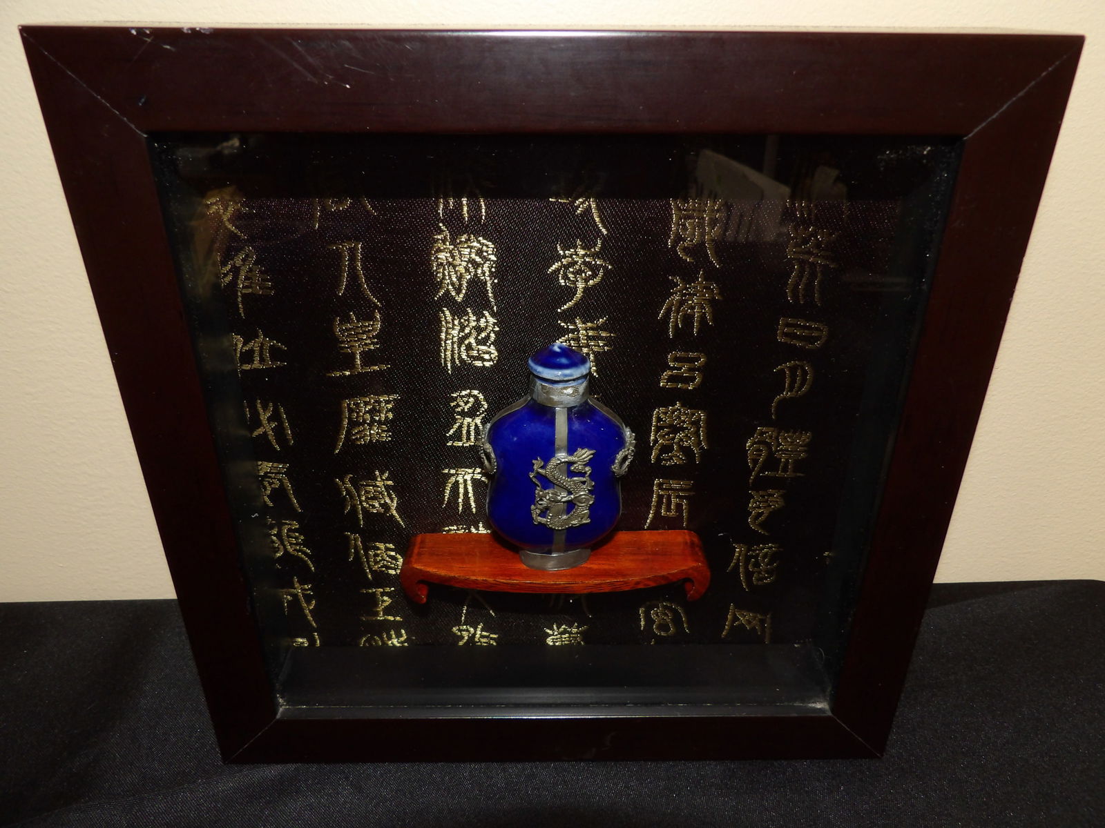 framed Tibetan snuff bottle in a shadow box: Size is 8.7 x 8.7 x 1.6 inches.