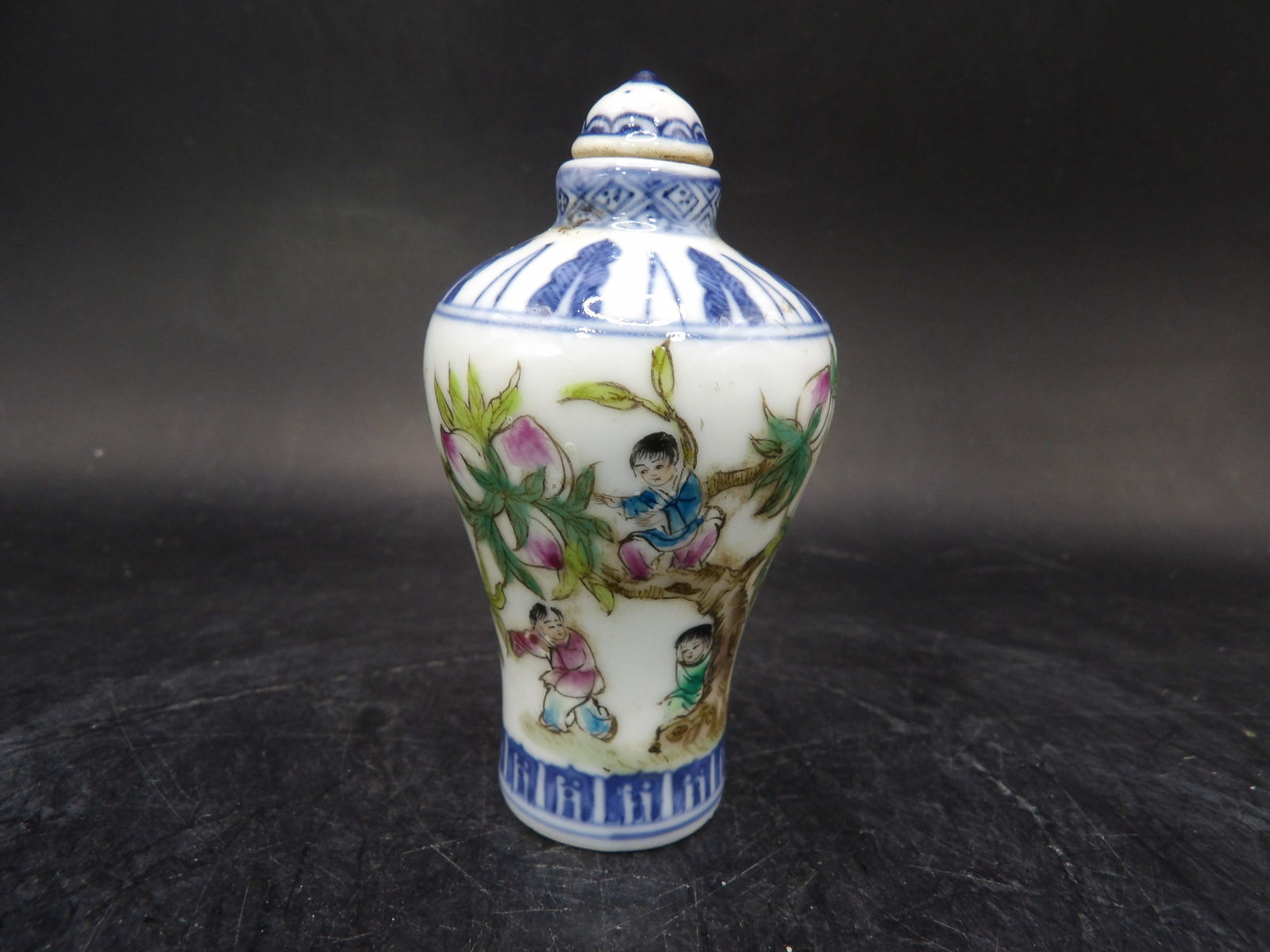 Chinese porcelain hand painted children with peach tree snuff bottle signed: 2.9 inches height.