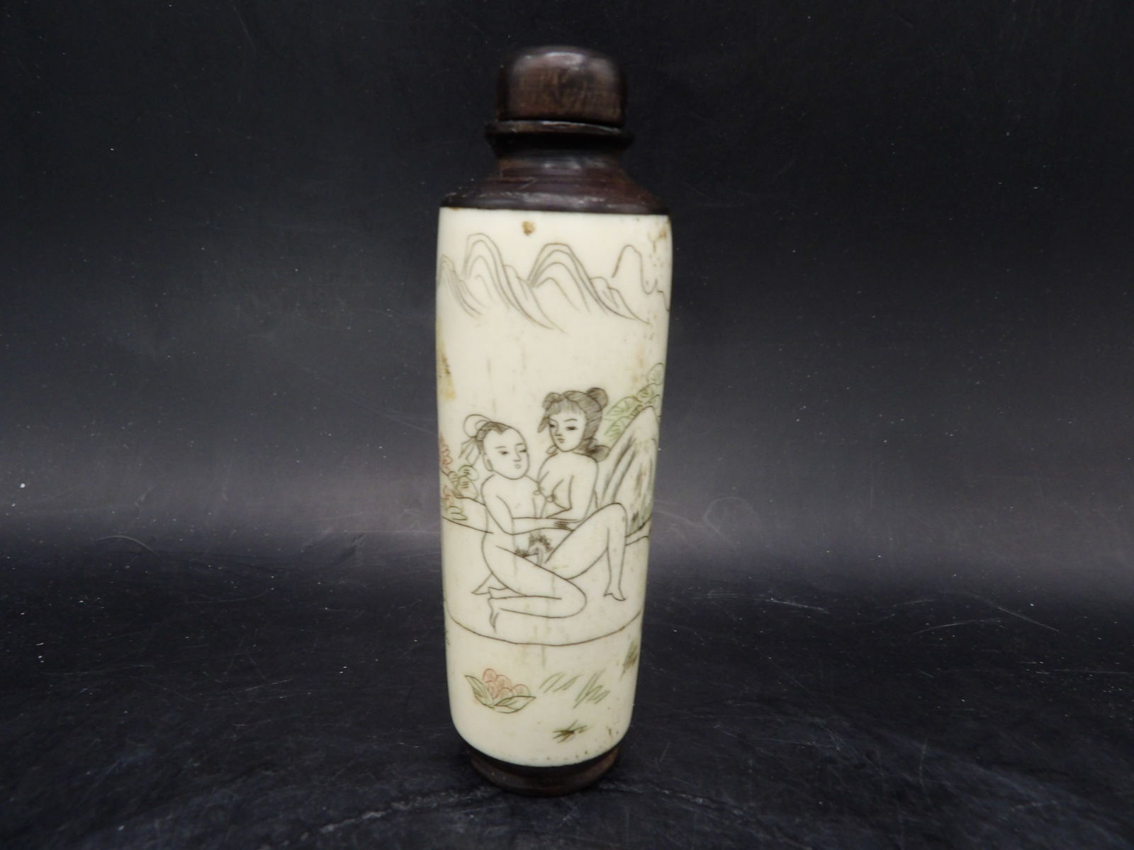 antique Chinese carved bone tall snuff bottle with erotic scenes and wood stopper: 3.7 inches height.
