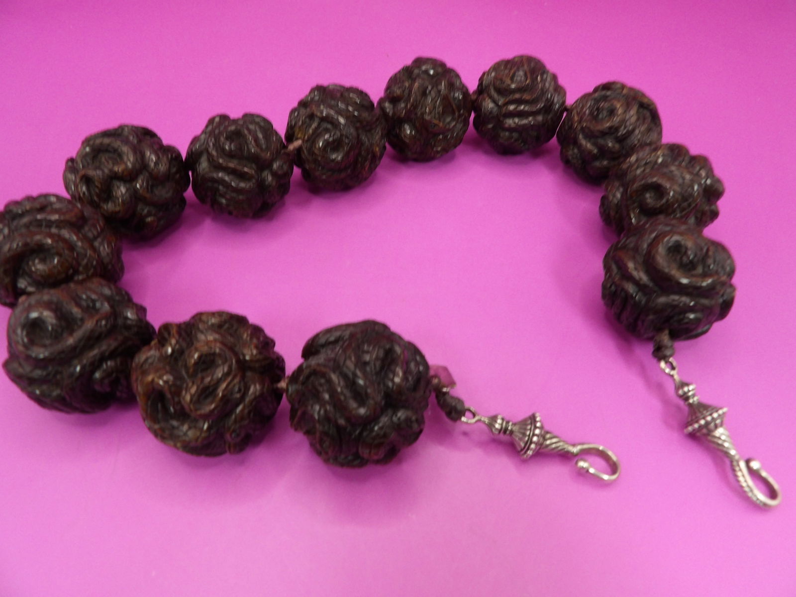 rare Sterling clasp carved multiple snakes large bead necklace with maker's tag: 21 inches long. 316 grams. Marked Sterling on maker's tag. Unsure about bead material. Fine carving of multiple snakes on each bead.