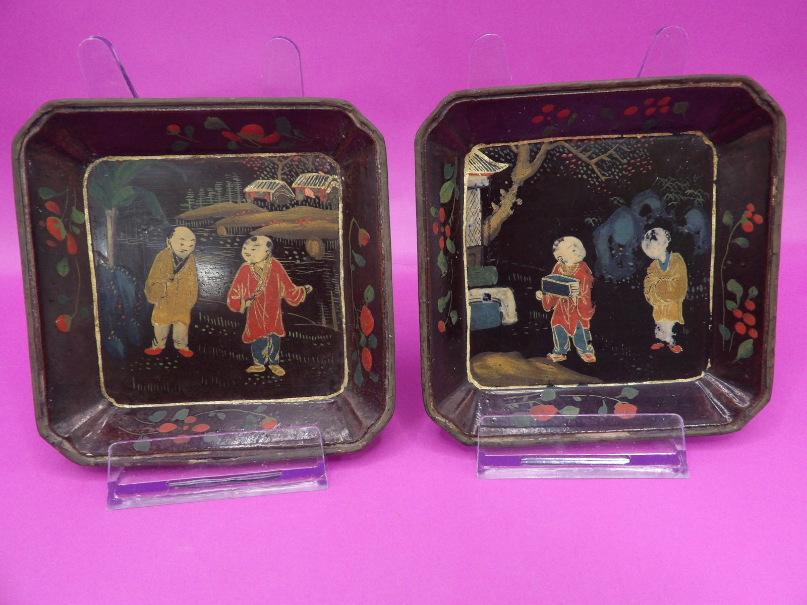 antique Chinese or Japanese black lacquer trays with polychrome painted children scenes: 4 inches height. Brown area on the bottom of one tray is old paper.
