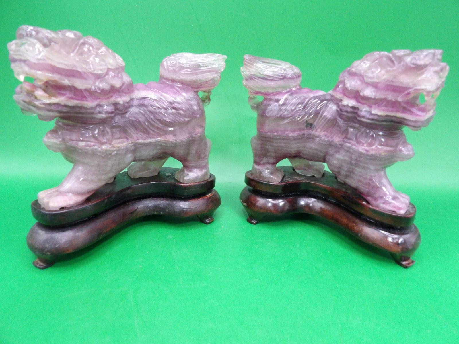 lot of 2 Chinese amethyst carved beasts on wooden bases: 4 inches length. 885 grams.
