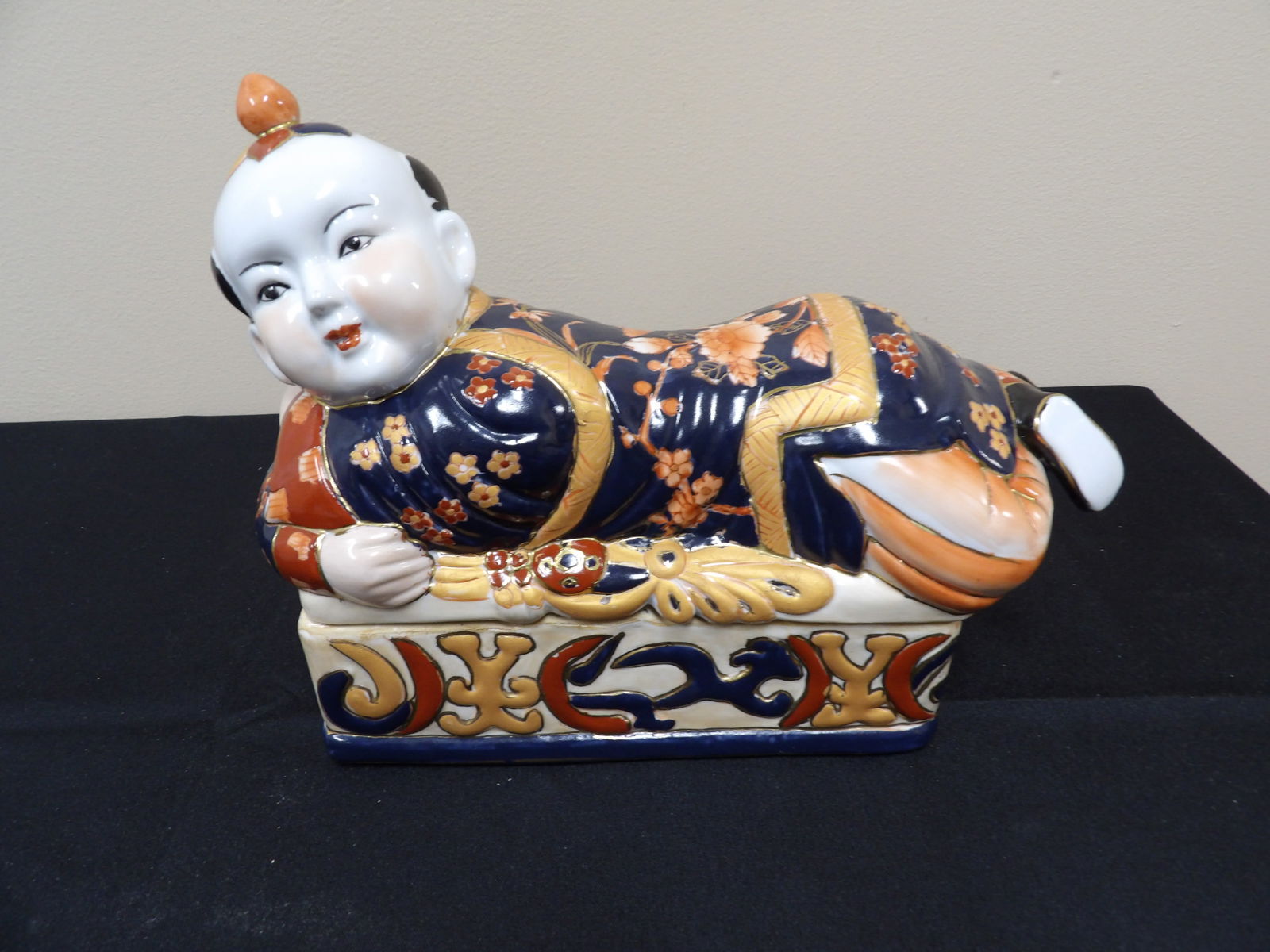 Chinese molded porcelain lying boy figural lidded box: 10.5 inches length.