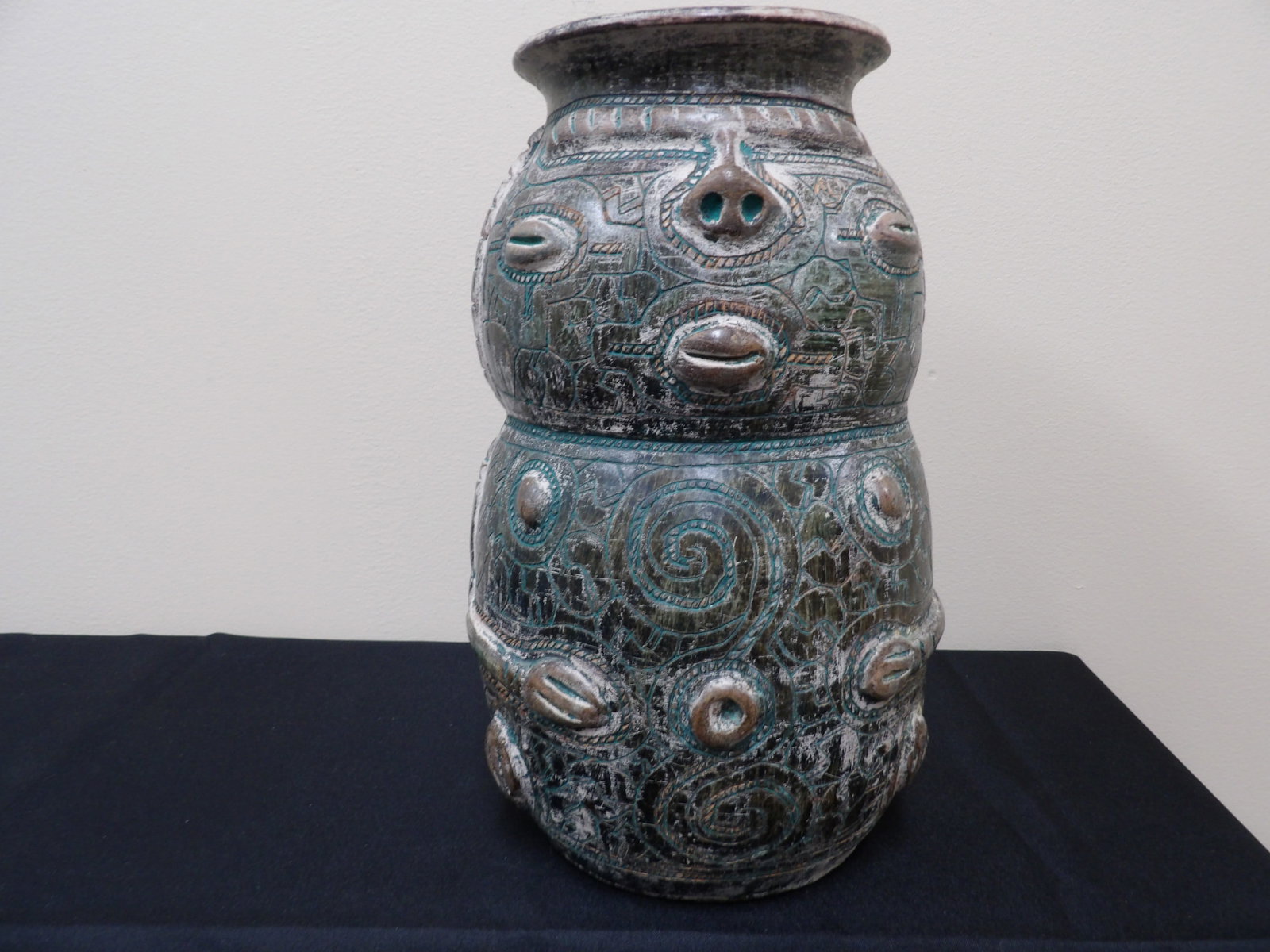 Brazilian glazed and incised pottery vase with face motif 12 inches height: 12 inches height.