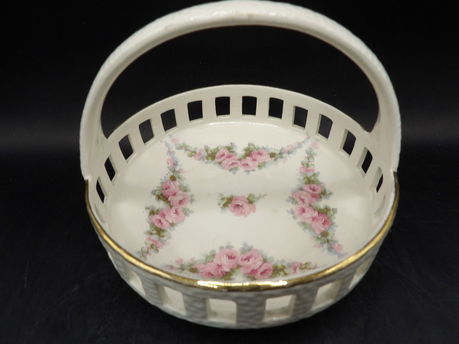 antique Max Roesler pierced porcelain basket with pink roses and gold trim: 6 inches length.