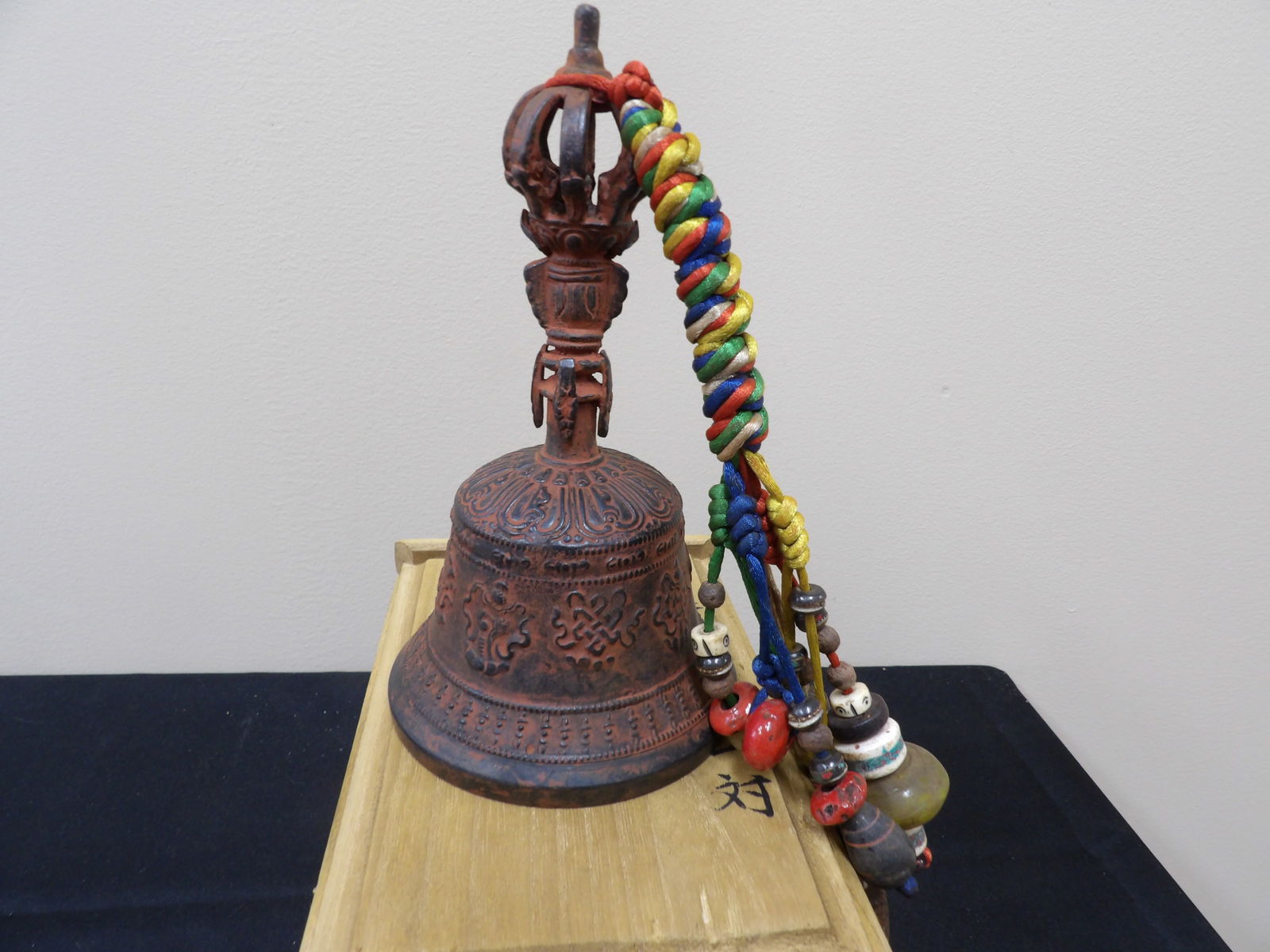 Chinese Tibetan Buddhist ritual bell with charms in a wooden box: Approx. 7 inches height.