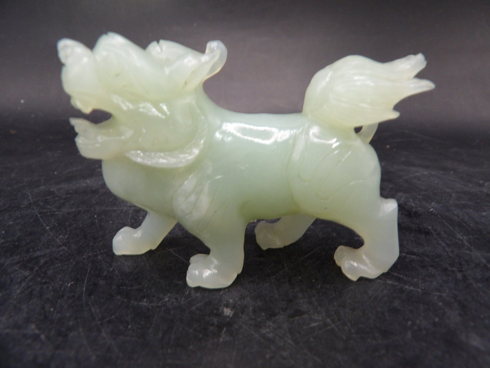 Chinese jade carved guardian lion figurine: 2.5 inches length. 57 grams.
