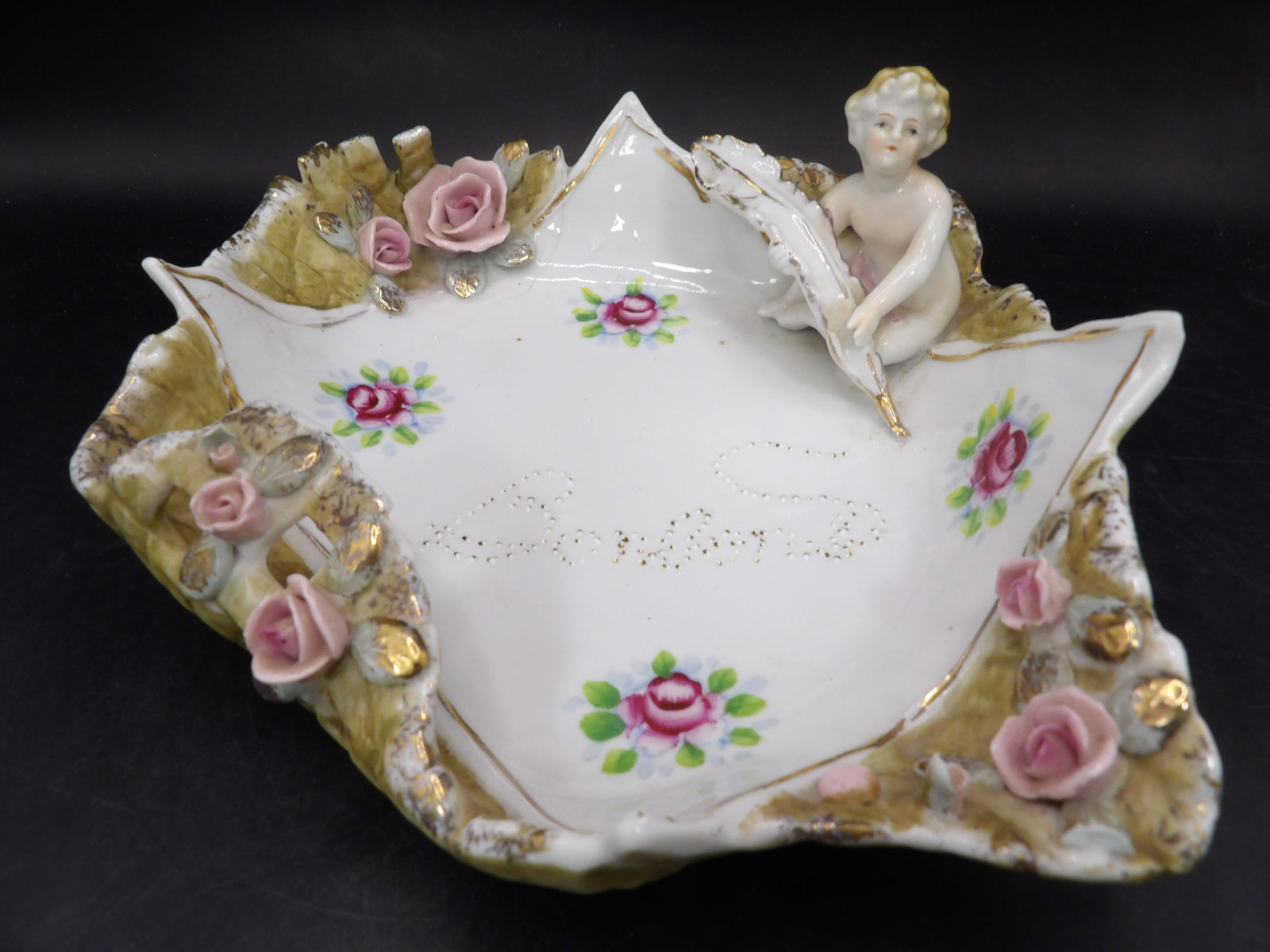 antique Rococo porcelain dish with cherub and pink roses: 7.5 inches length.
