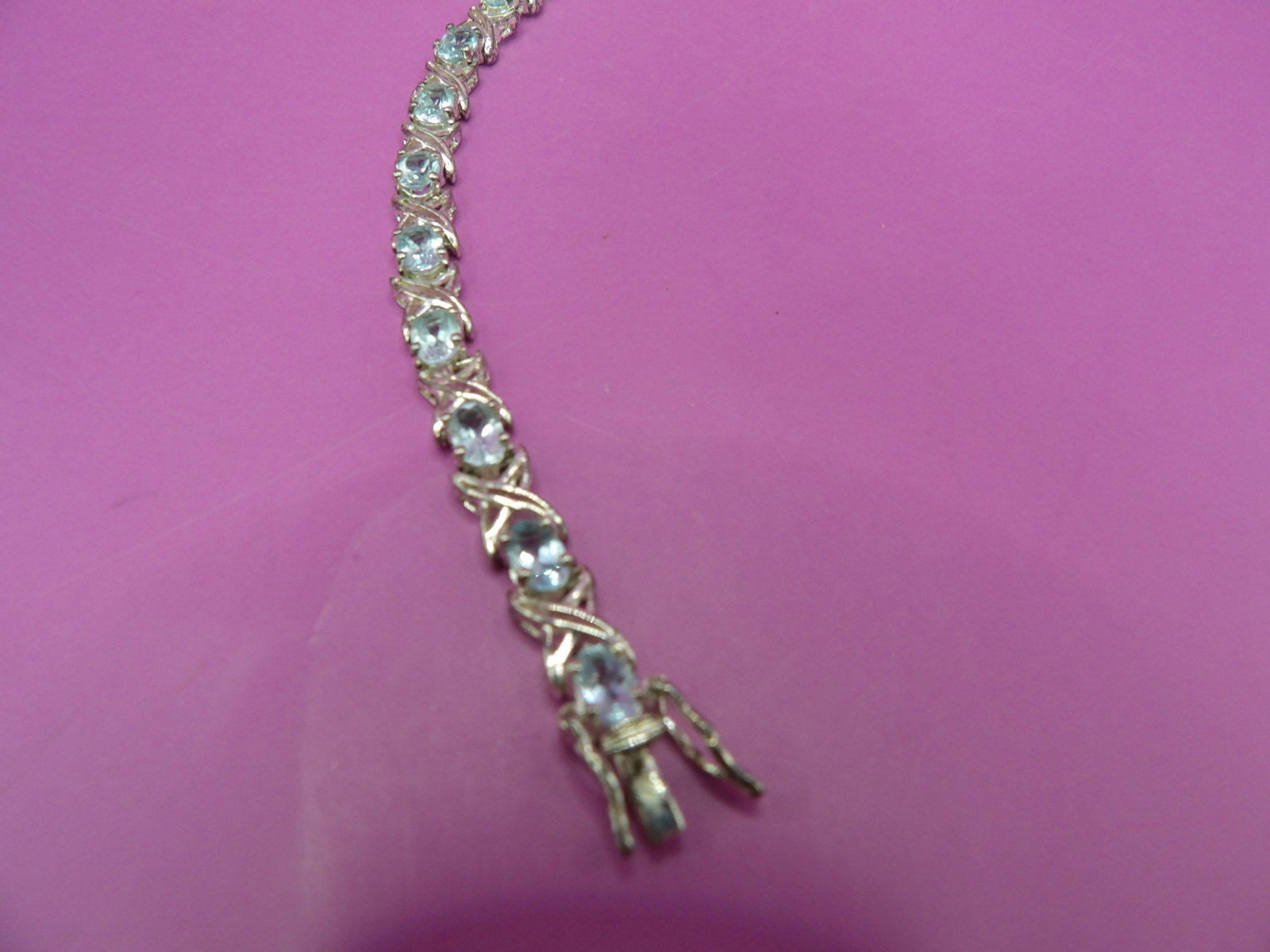 marked 925 sterling silver aquamarine gem stone X links tennis bracelet: 7.25 inches length.