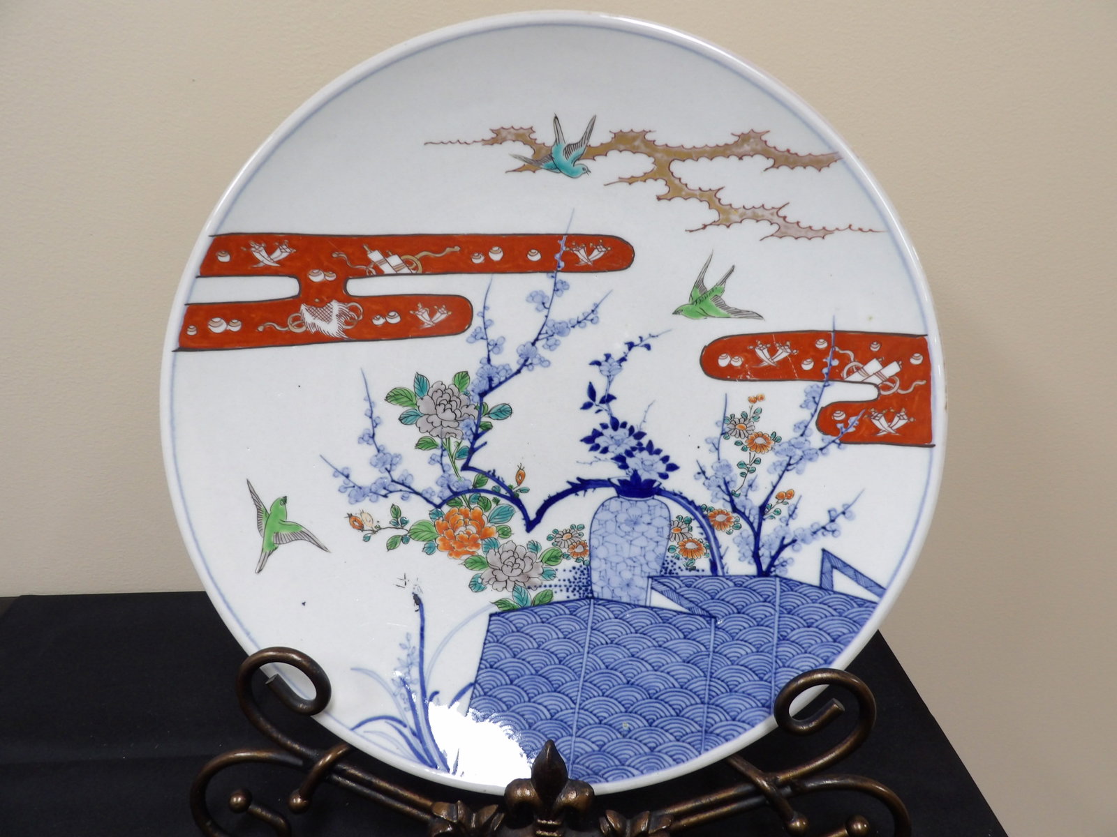 Meiji or Taisho period Japanese antique charger with birds and floral motifs: 16 inches diameter. Metal display base is not included.