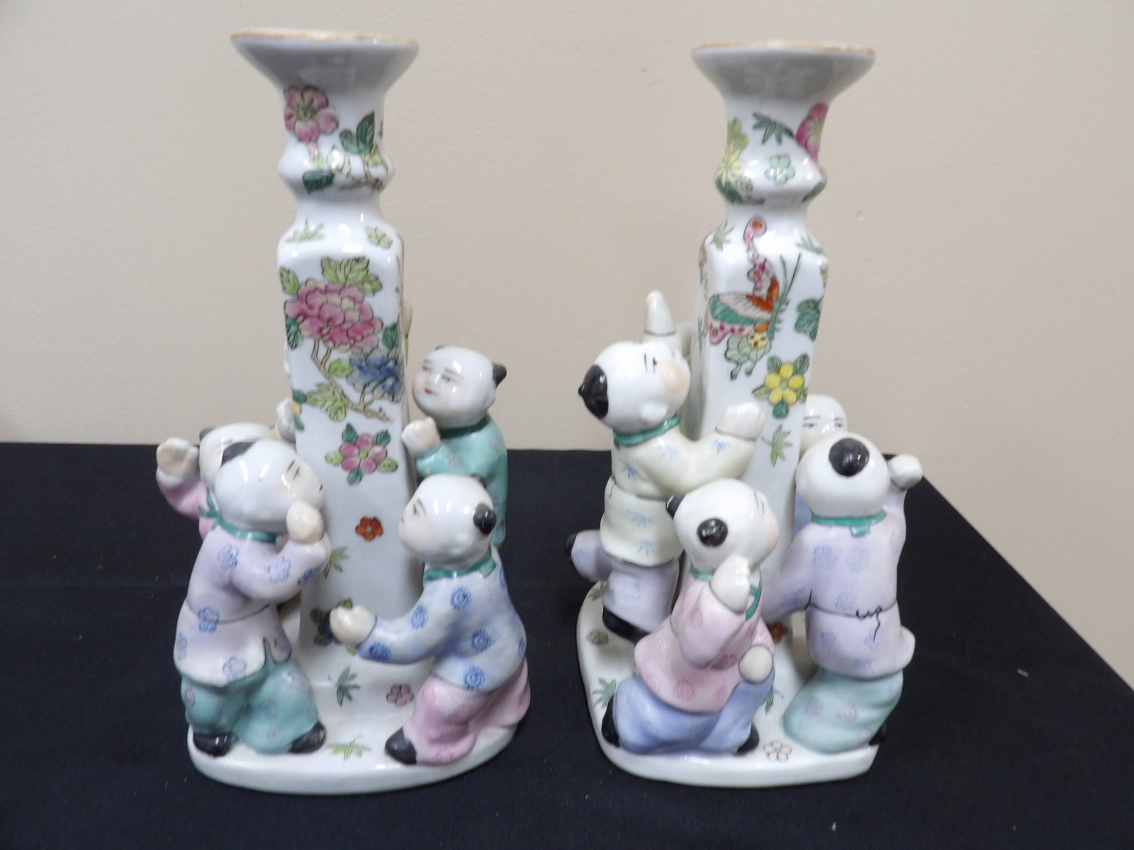 pair Chinese molded porcelain candle holders with children climbing scene: Approx. 10 inches height.