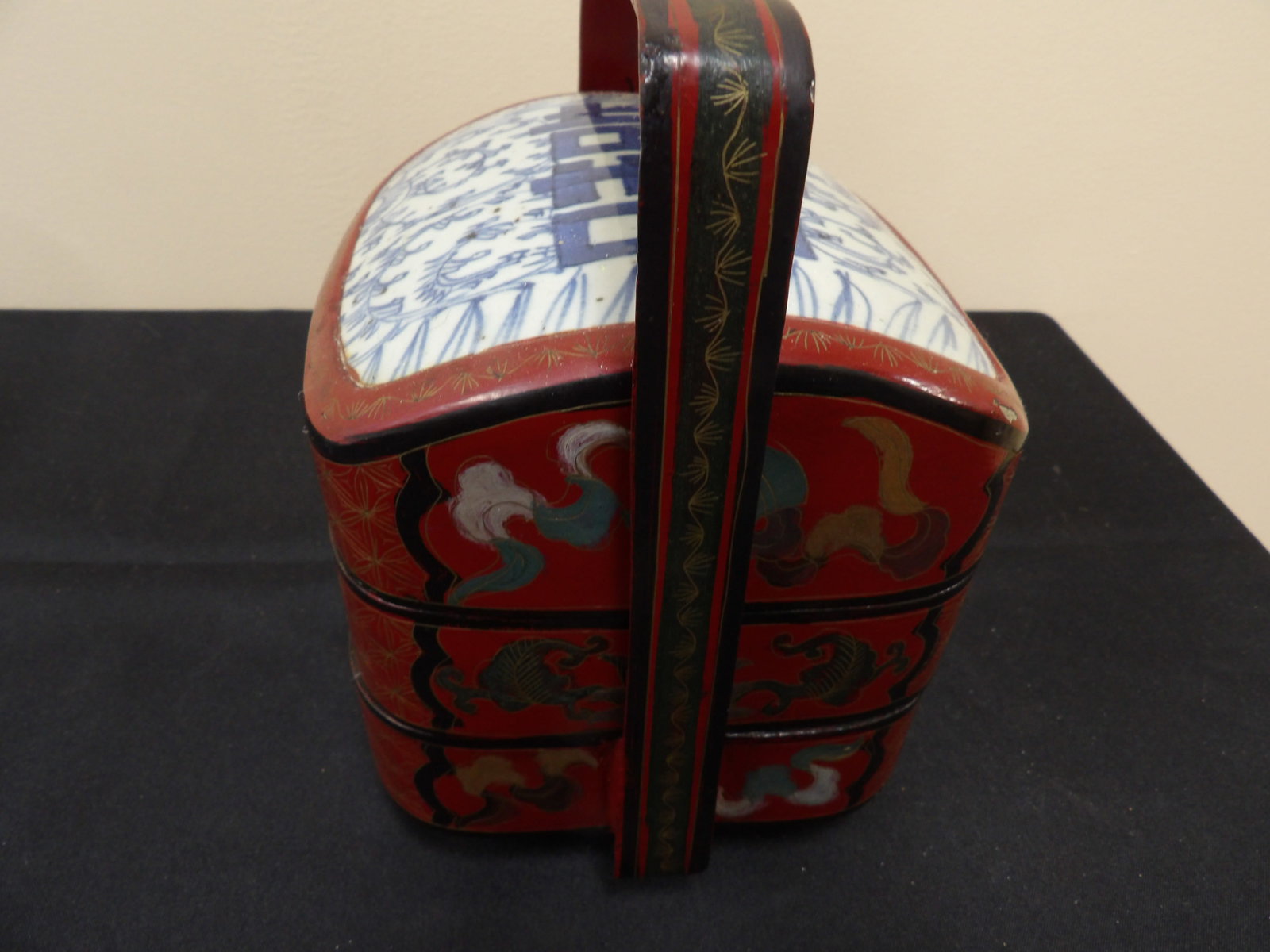 Chinese lacquered tiered wedding basket with blue and white happiness porcelain lid: 8.5 inches height.