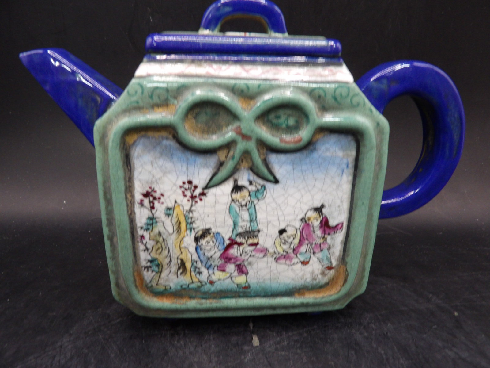 Chinese enamel painted Yixing teapot with children playing scene and Qing dynasty Qianlong mark: 6.5 inches length.