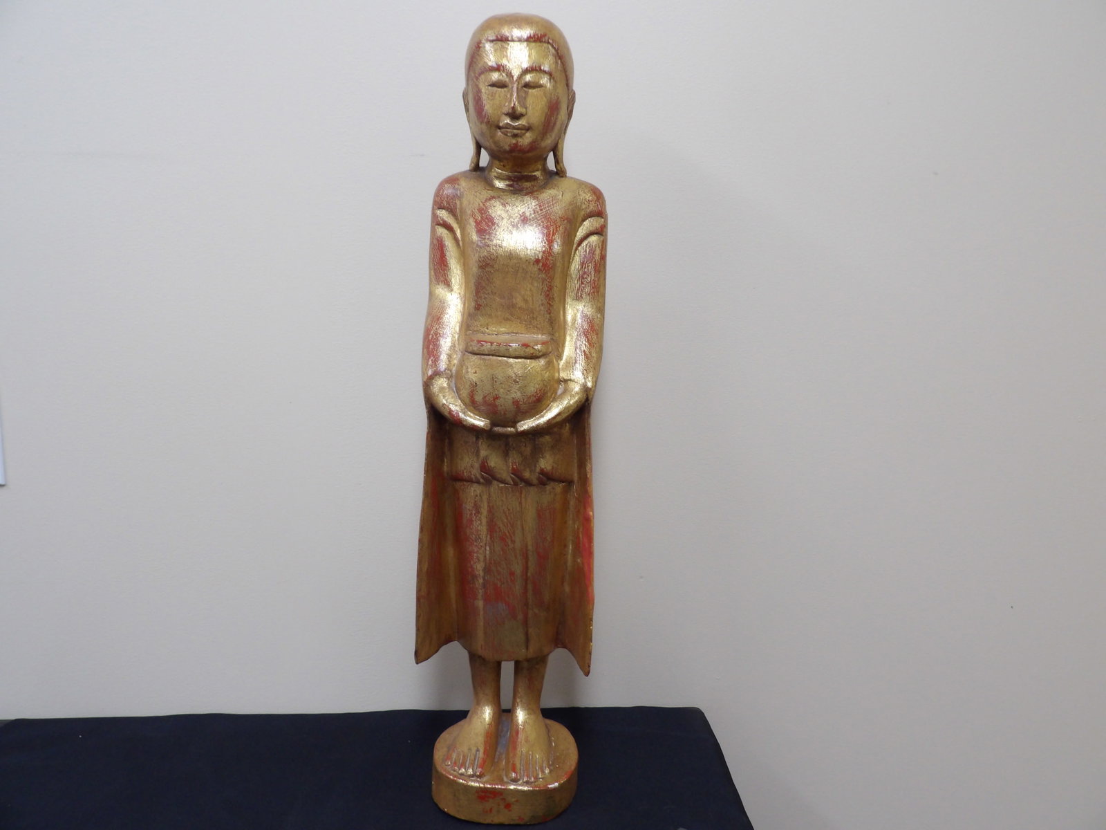 antique tall giltwood standing Southeast Asian figure holding an alms bowl: Approx. 30 inches height.