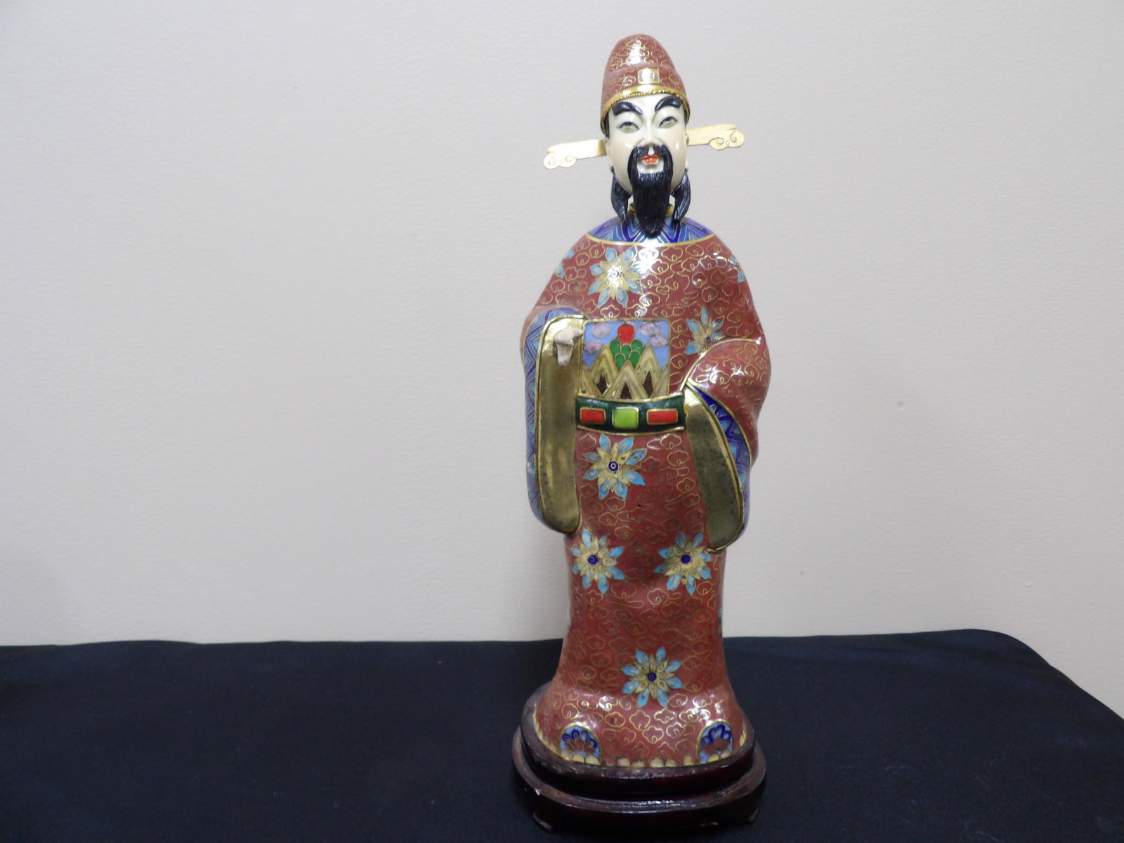 Chinese cloisonne enamel figurine of a deity adhered to wooden base: 14.4 inches height including wood base.
