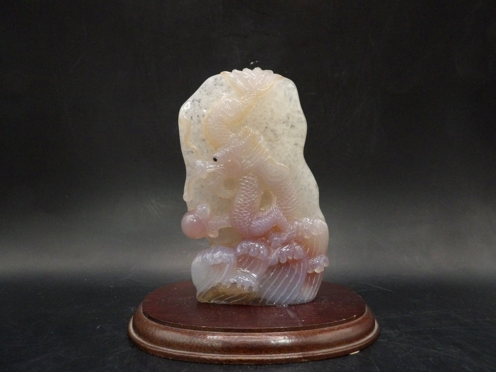Fine Chinese carved dragon playing a pearl on wooden base probably fluorite: Carving is 5 inches height. With base 5.5 inches height.