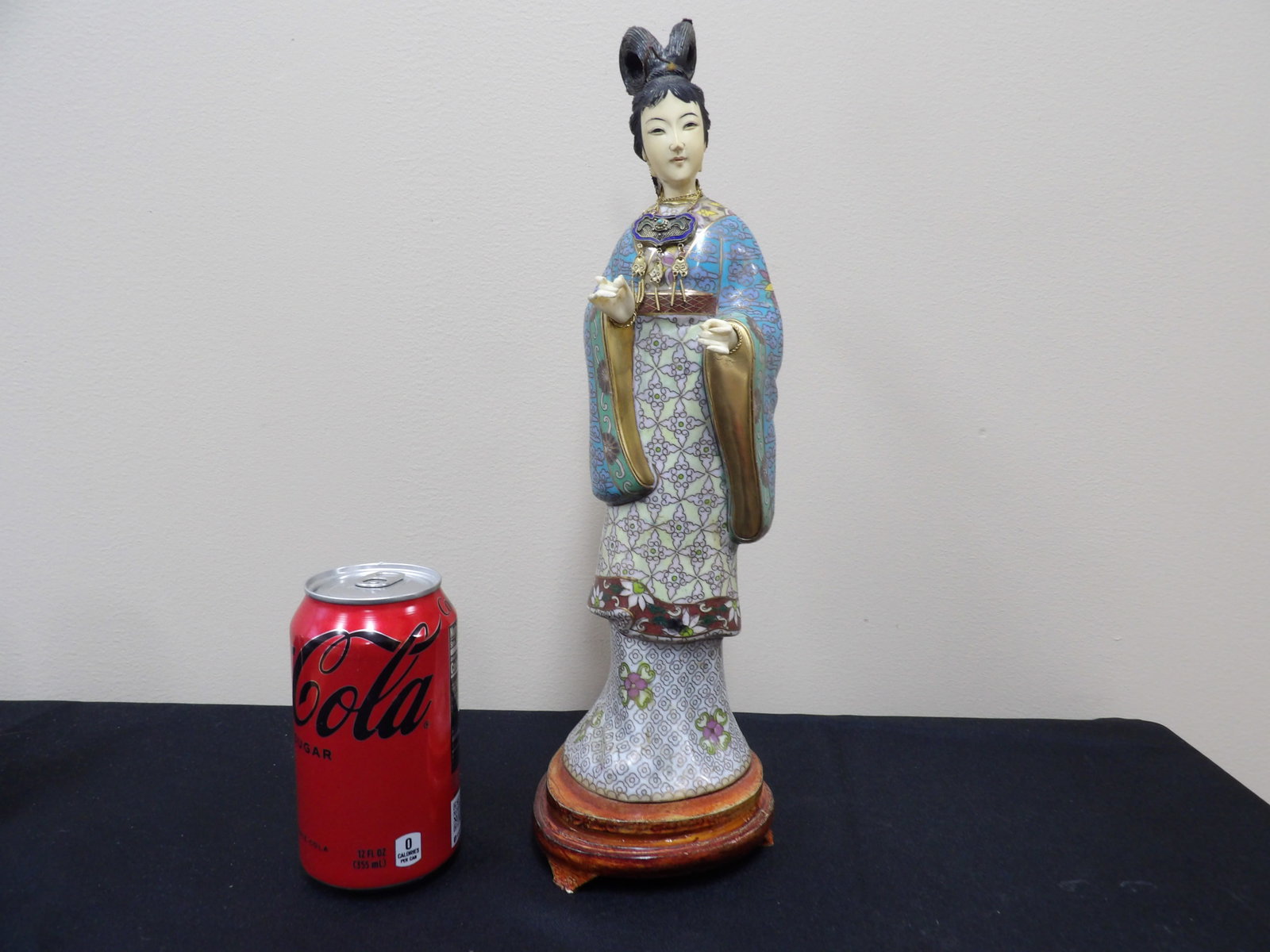 antique Chinese cloisonne female figurine with carved face and hands: Figurine is adhered to wooden base and total height is 14 inches.