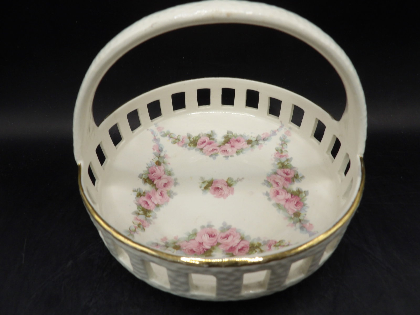 antique Max Roesler pierced porcelain basket with pink roses and gold trim: 6 inches length.