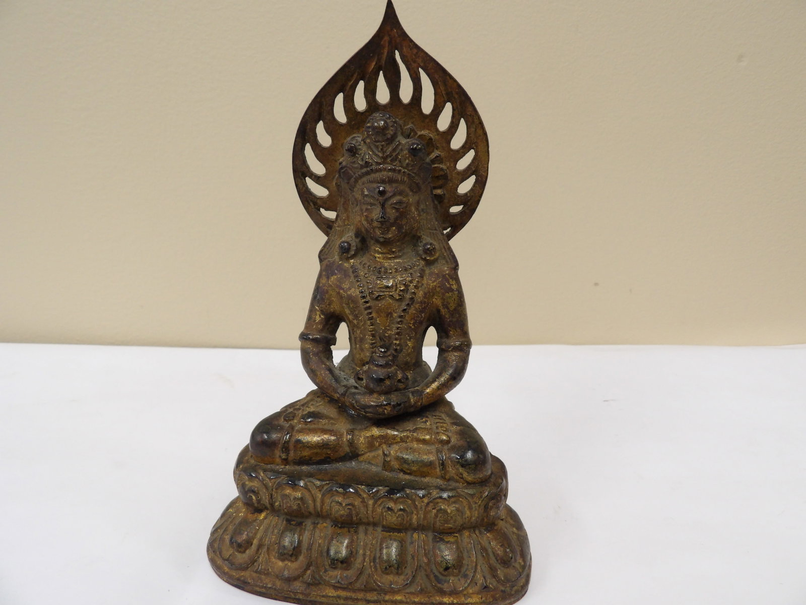 antique Chinese or Japanese gilt bronze seated buddha figurine with flame halo and lotus base: 6.3 inches height.