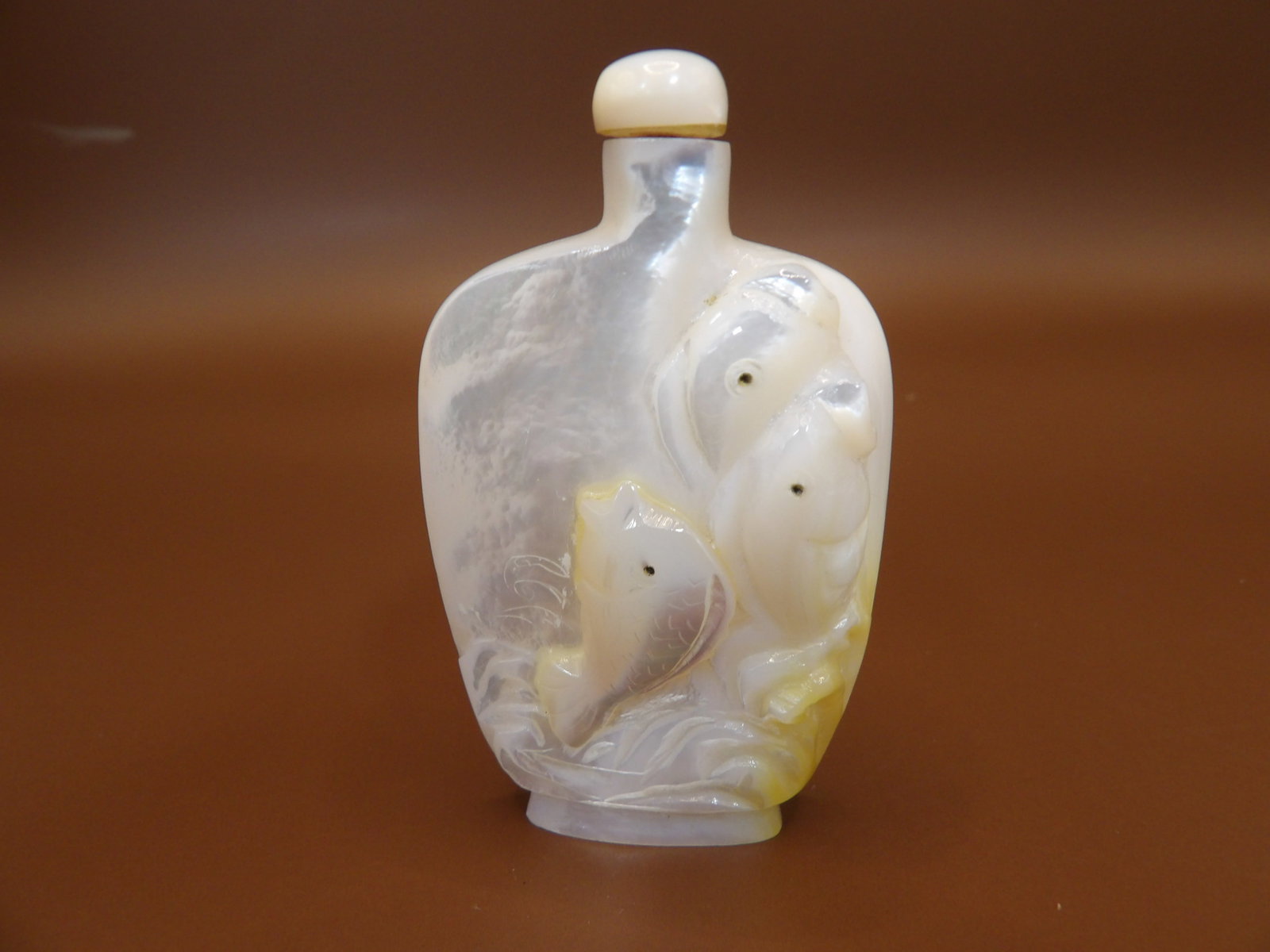 fine Chinese mother of pearl carved snuff bottle with raised fish motif: 2.8 inches height.