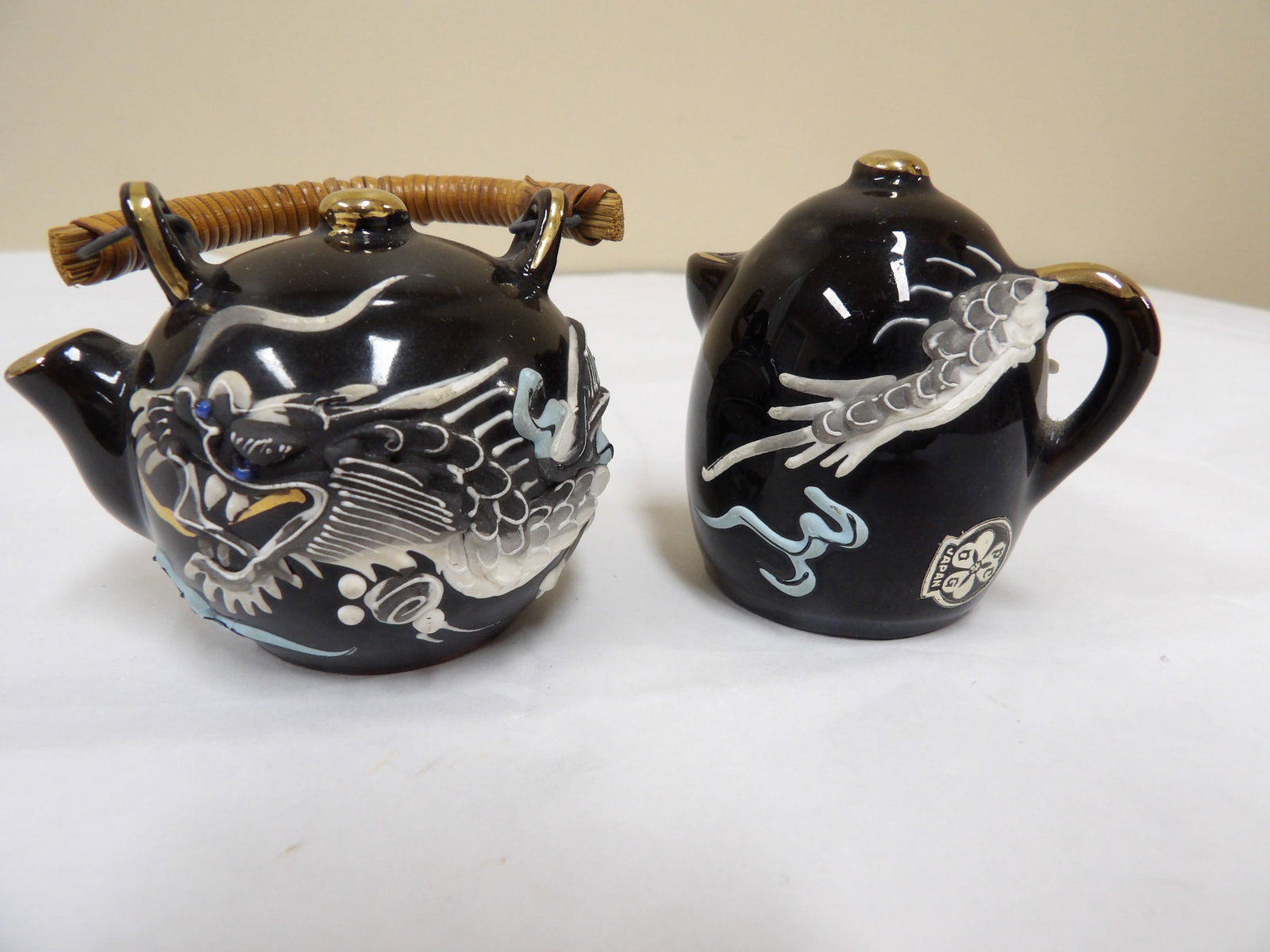pair of Japanese dragonware moriage salt and pepper porcelain shakers: Approx 2.3 inches height.