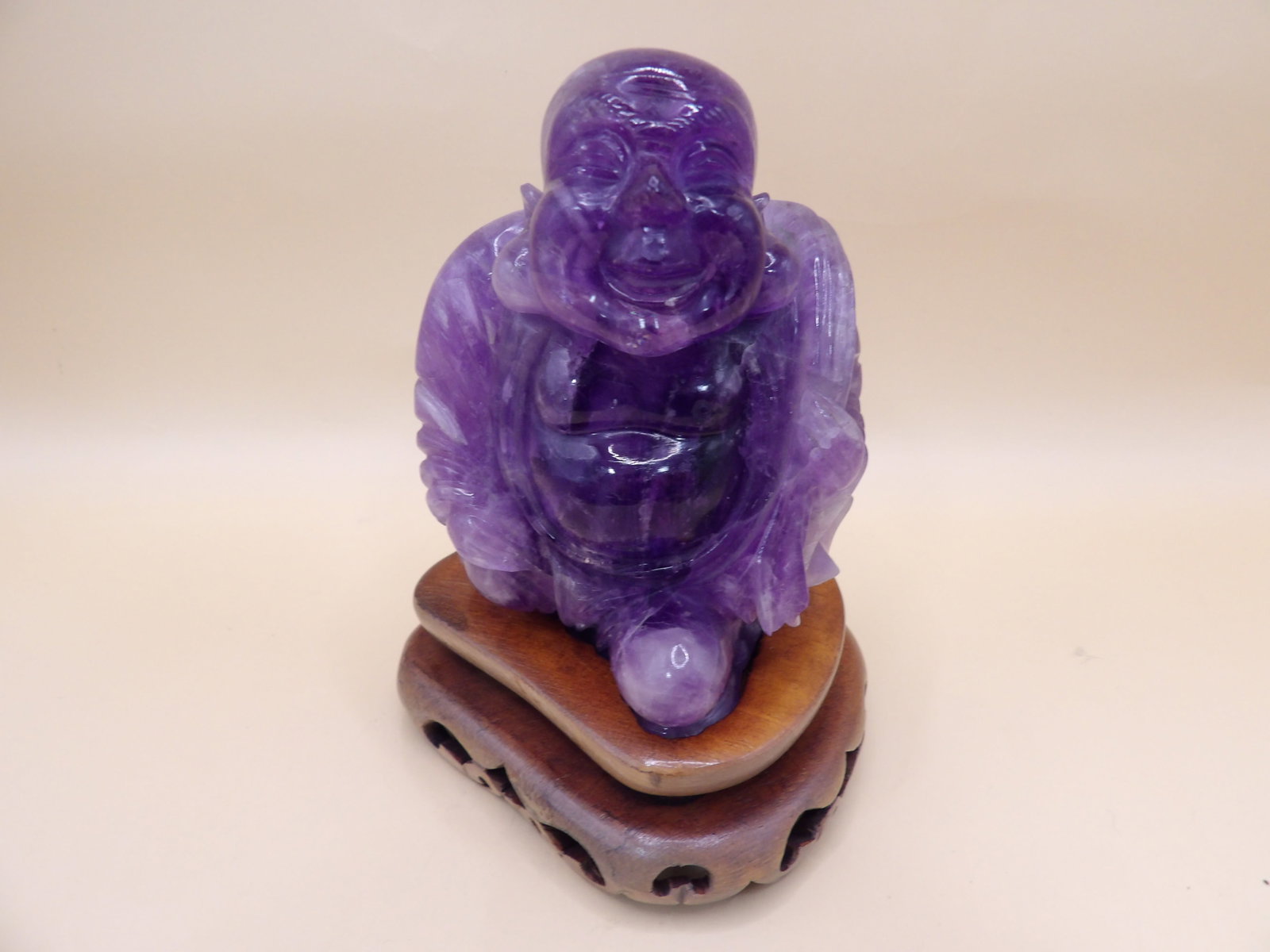 Asian very fine amethyst carved buddha figurine on wooden base: Figurine is adhered to wooden base. Total height is 4.5 inches. Total weight is 429 grams. We will inhouse ship items to you very affordable and efficient. Select self-arrange shipping.